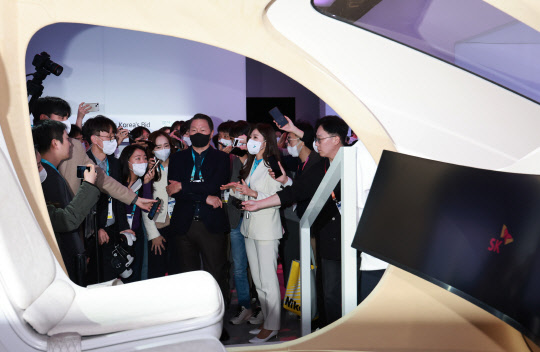 U최태원 SK 그룹 회장이 세계 최대 가전·IT(정보기술) 박람회 'CES 2023' 이틀째인 6일(현지시간) 미국 네바다주 라스베이거스 컨벤션센터(LVCC) 중앙홀의 SK 전시관을 찾아 SK텔레콤의 도심항공교통(UAM) 시뮬레이터를 살펴보고 있다.  연합뉴스